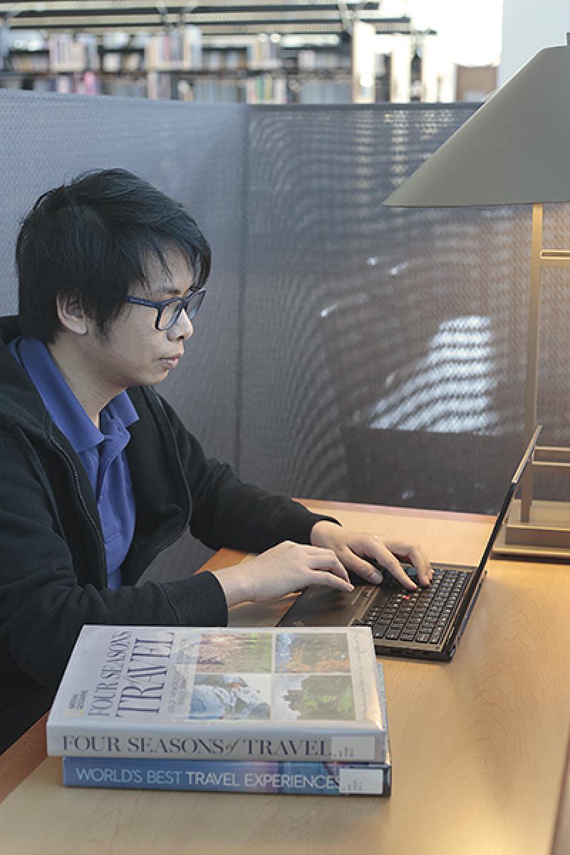 A photo of a student sitting at a desk