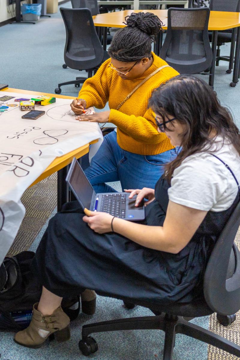 A photo of students working on a project at a table